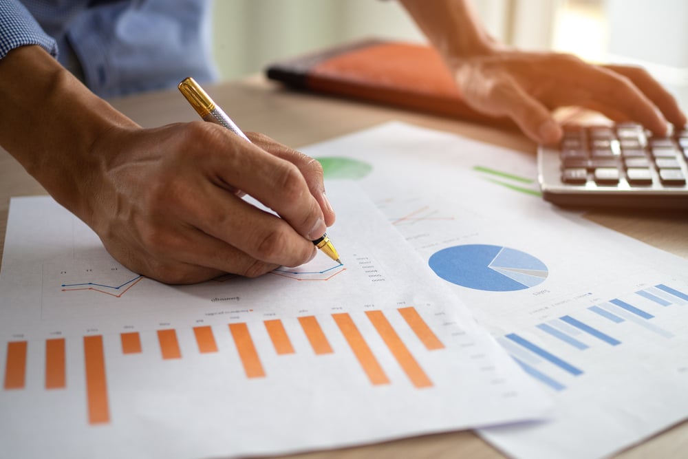 Businessman looking at financial charts and graphs 