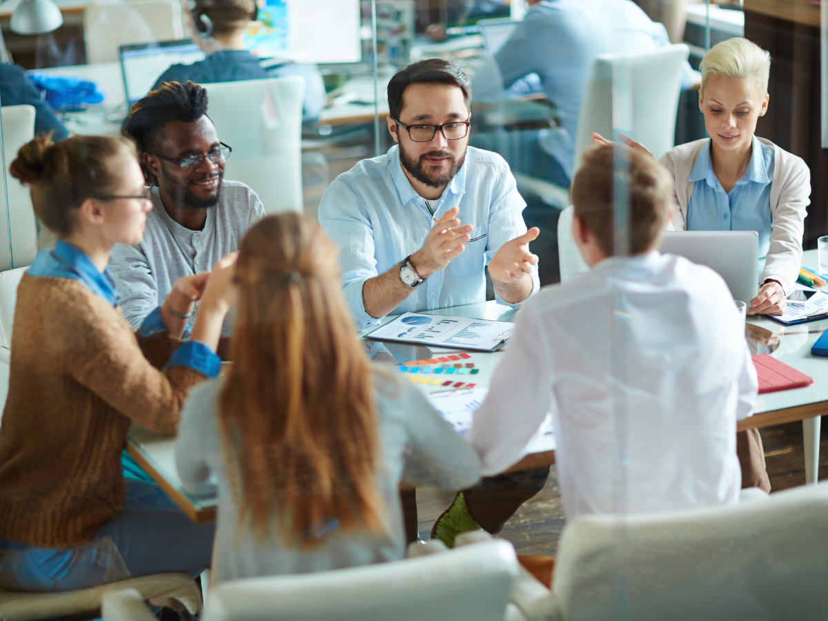 Co-workers working together around table